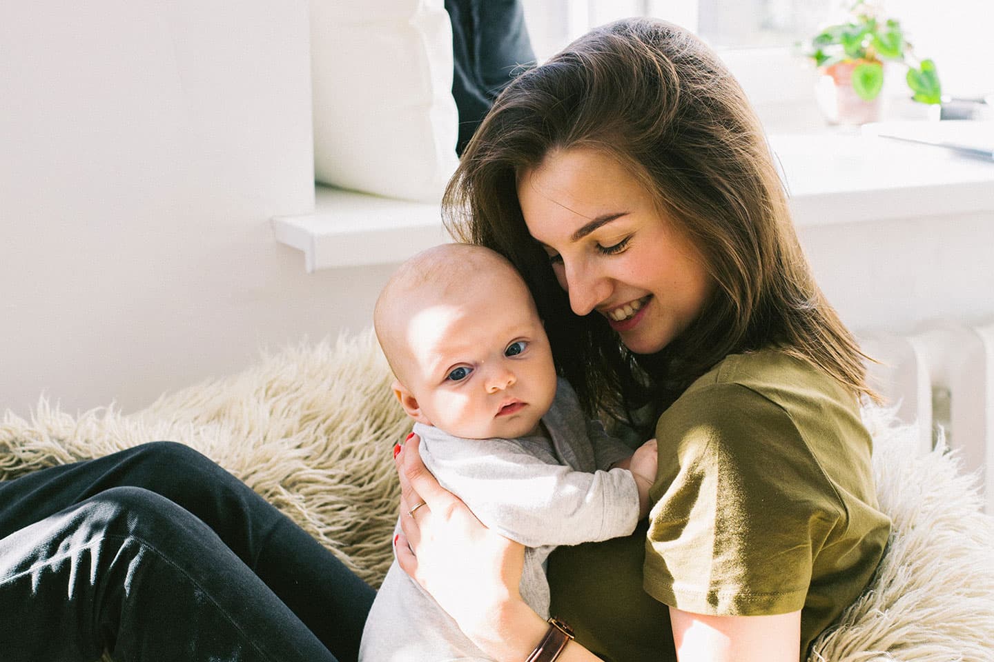 a woman holding a baby