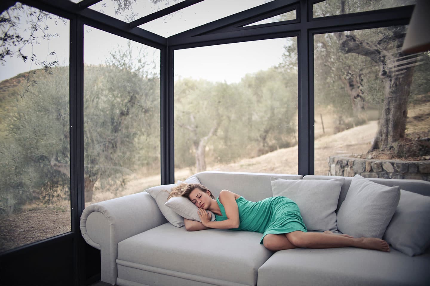 a woman taking a nap on her couch