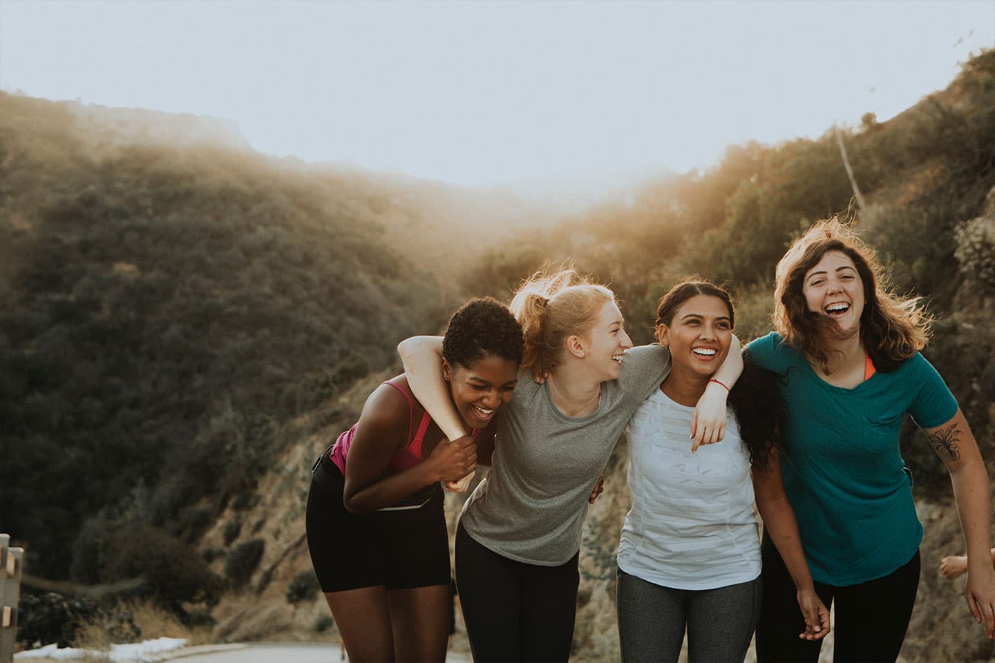 group of woman smiling together after a hike