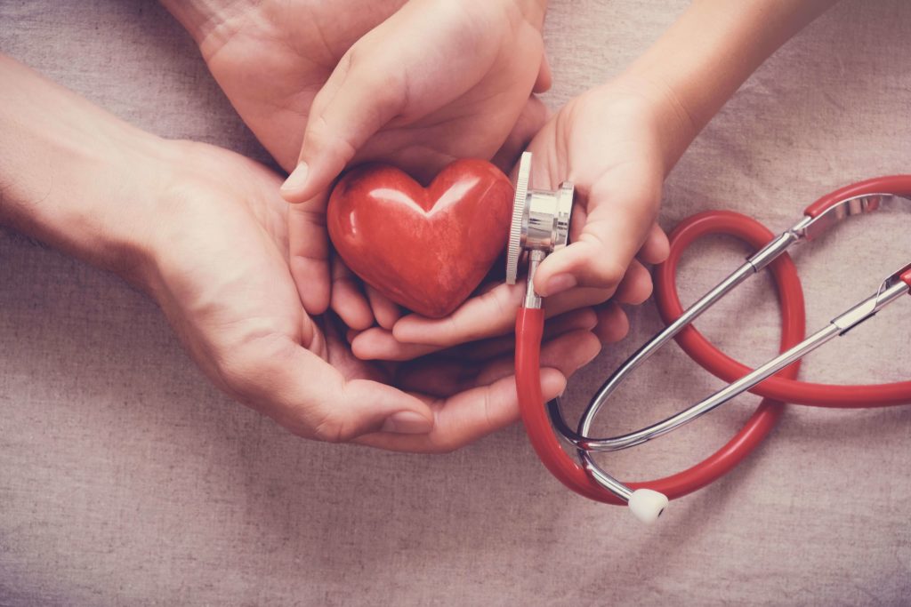 heart and stethoscope being held by mother and daughter