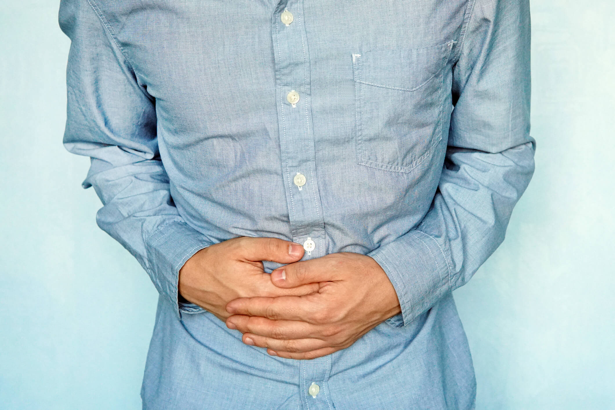 man holding his upset stomach