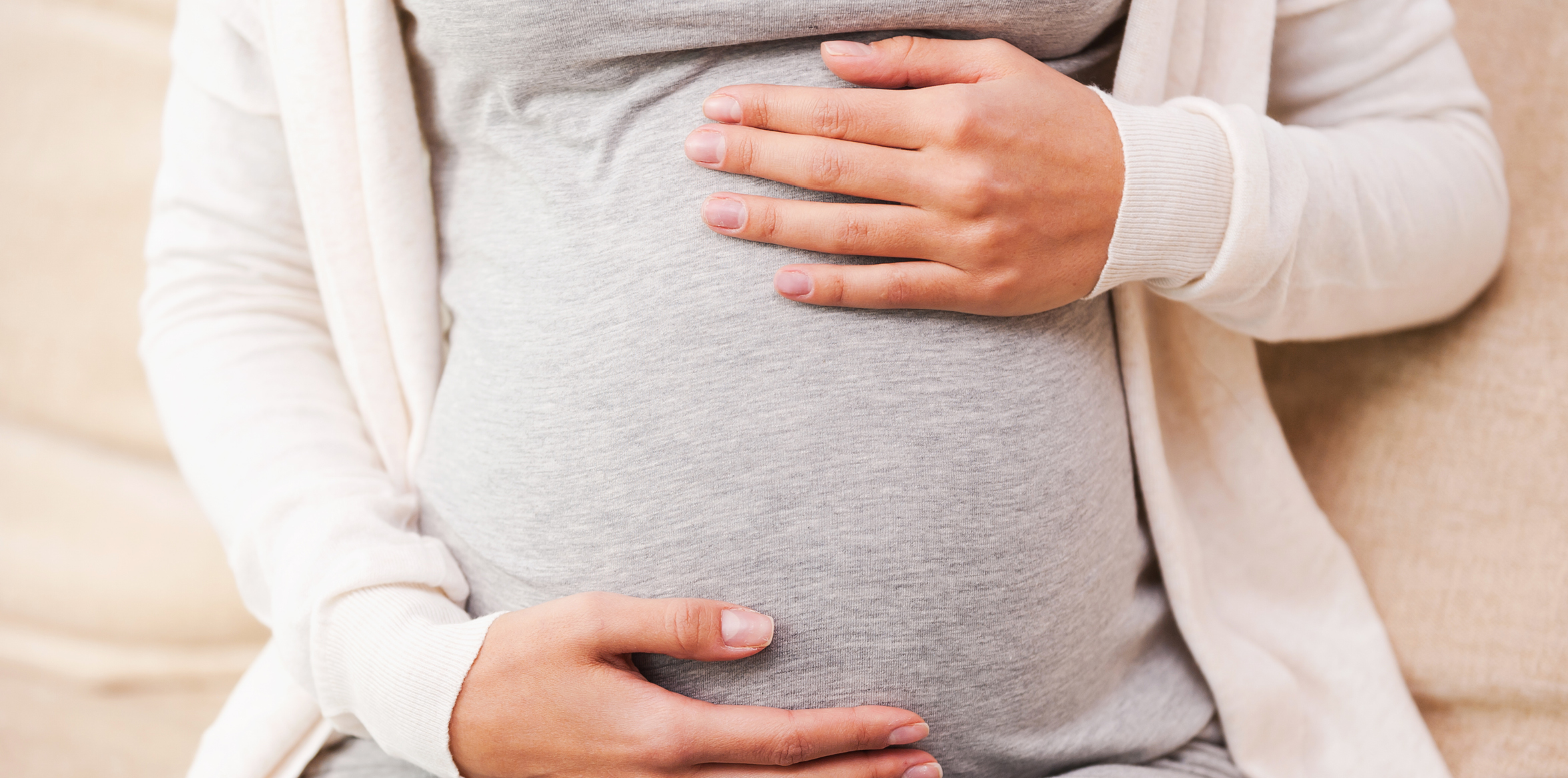 pregnant woman holding belly