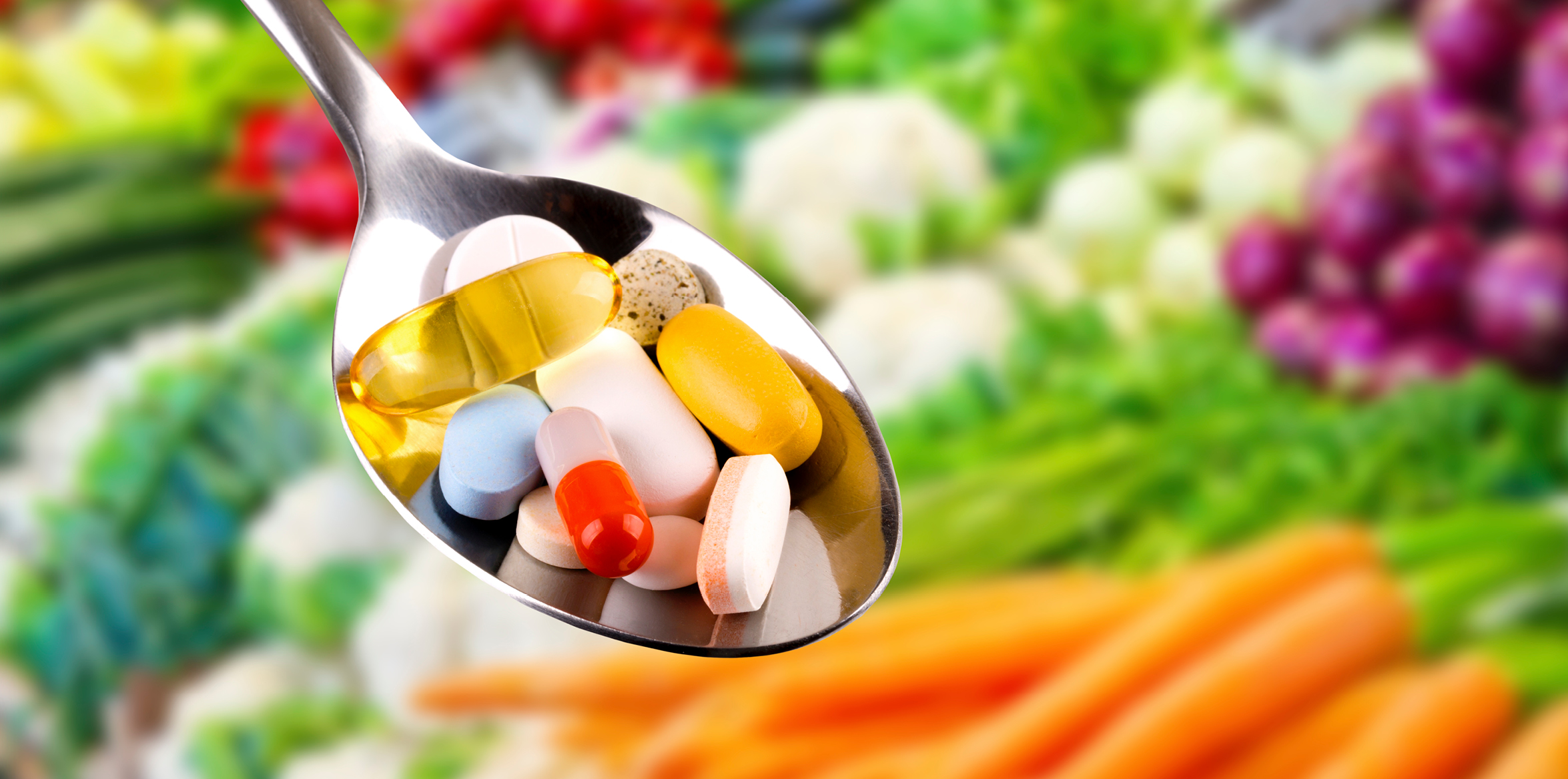Spoon filled with various pills