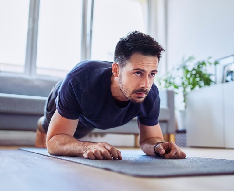 Man doing a plank exercise on a yoga mat